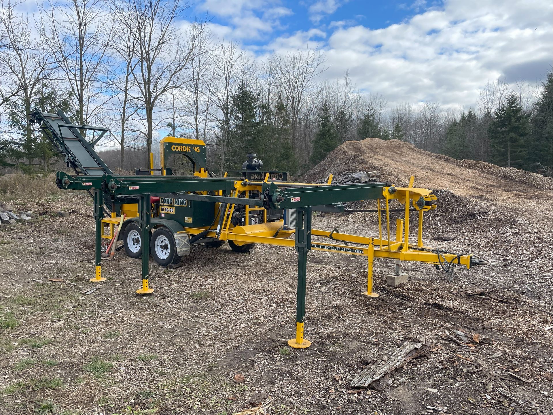 A yellow and green machine is parked in a field.