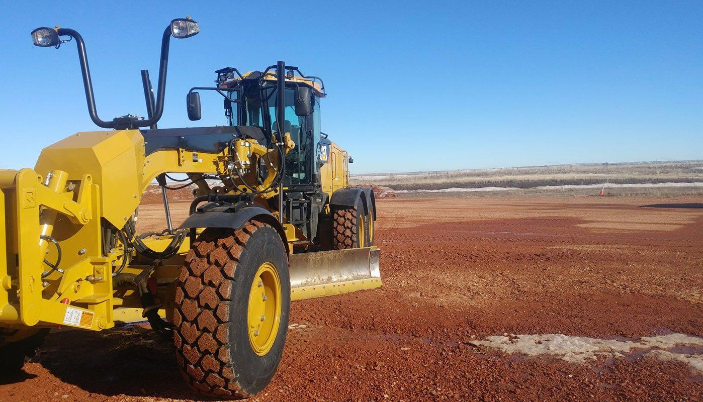 Side view of construction vehicle in dirt field
