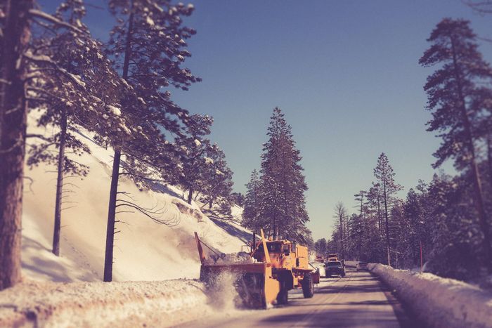 Truck removing snow on the road