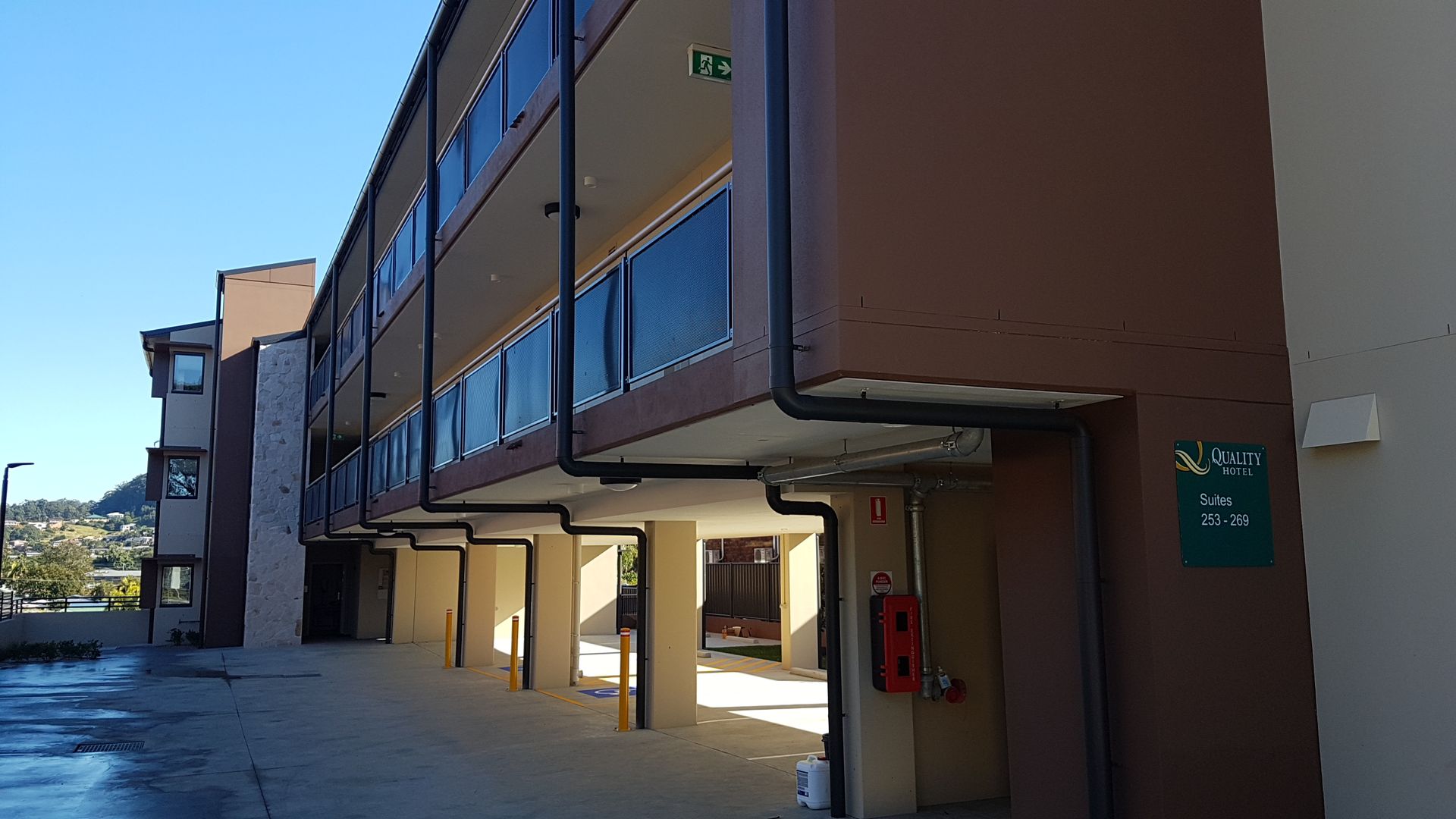 Brown and Tan Multi-story Building With a Covered Walkway Underneath — Acheson Building Certification in Nambucca Heads, NSW