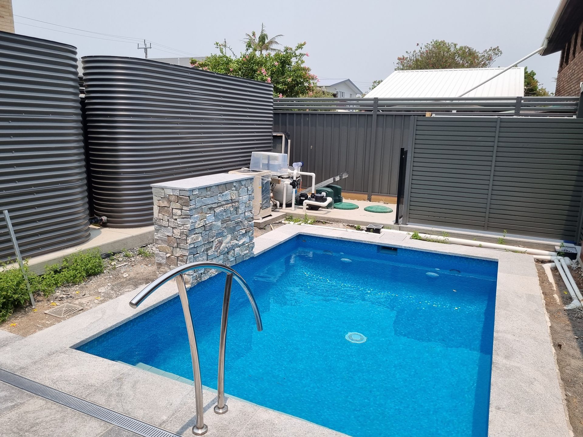 Small Blue Swimming Pool With Metal Ladder — Acheson Building Certification in Nambucca Heads, NSW