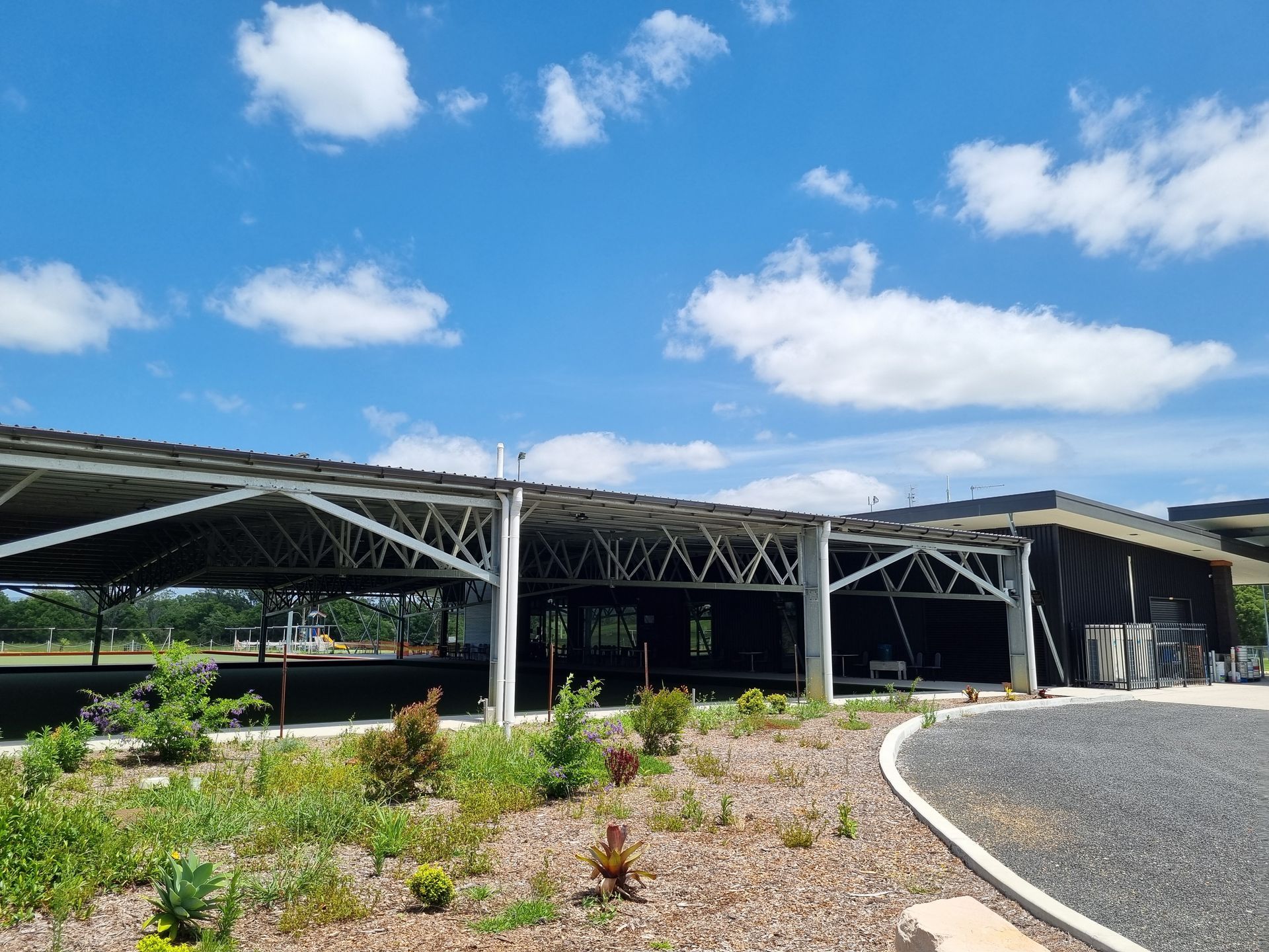 Open-air Shelter With Metal Frame and Dark Building Against a Sky — Acheson Building Certification in Nambucca Heads, NSW