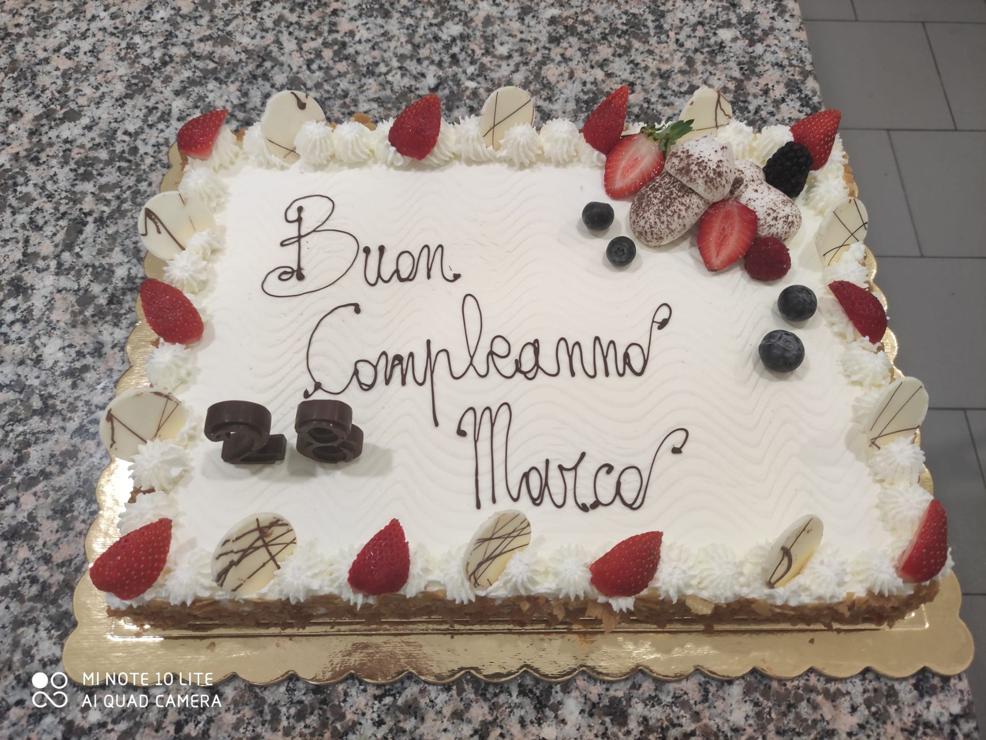 A birthday cake that says buon compleanno marco on it