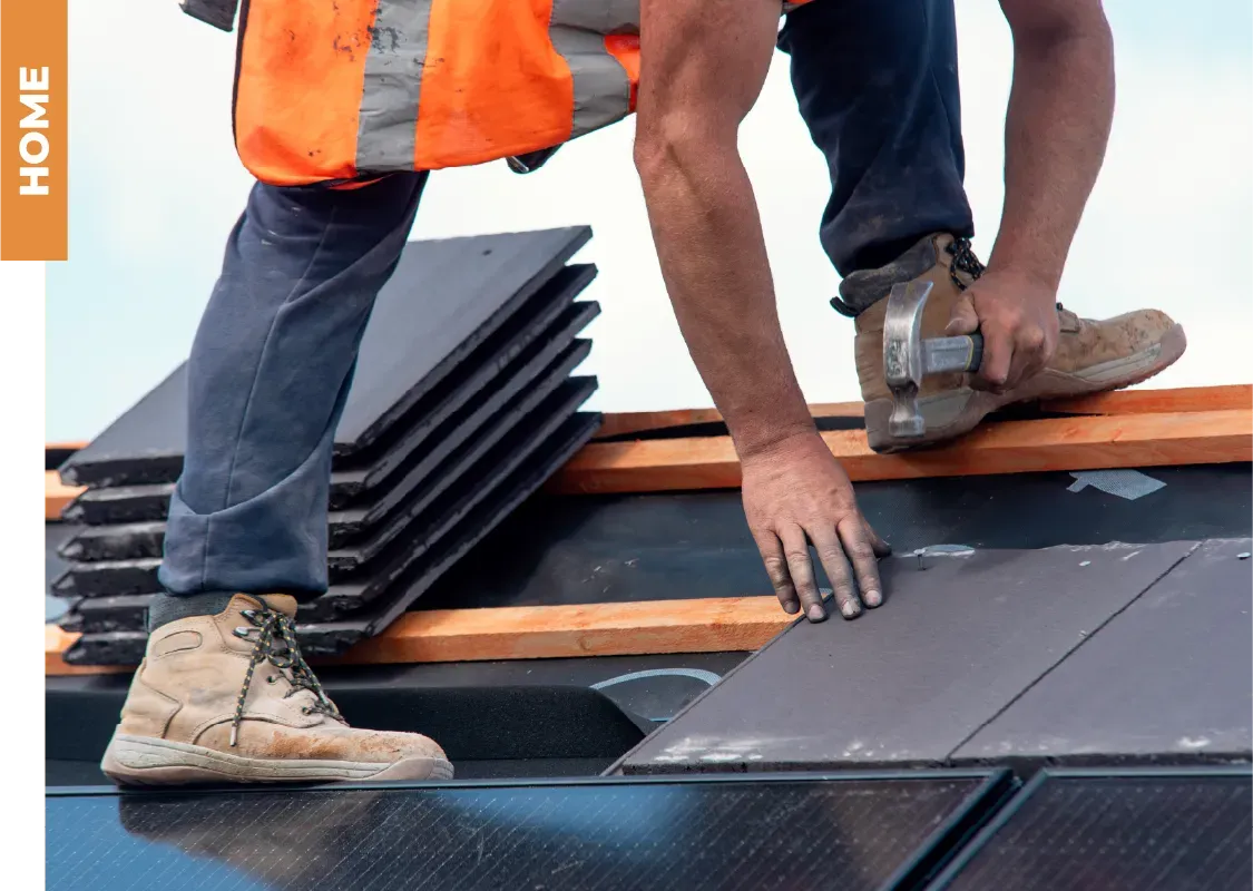 A man is working on a roof with the word home in the corner