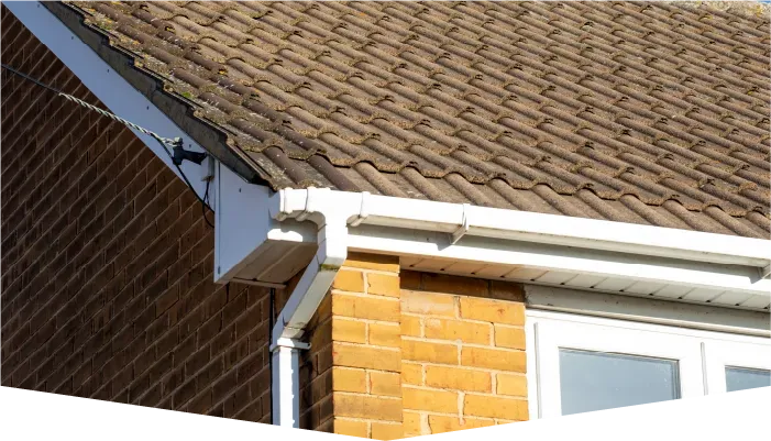 A house with a brown roof and a white gutter