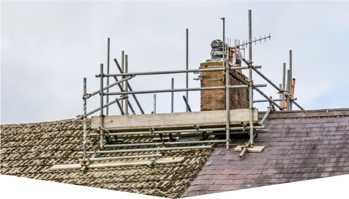 A chimney on top of a roof with scaffolding around it