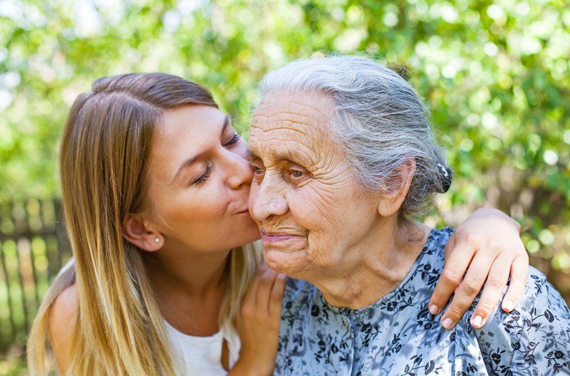 Health — Woman Kissing a Senior Woman in Redlands, CA
