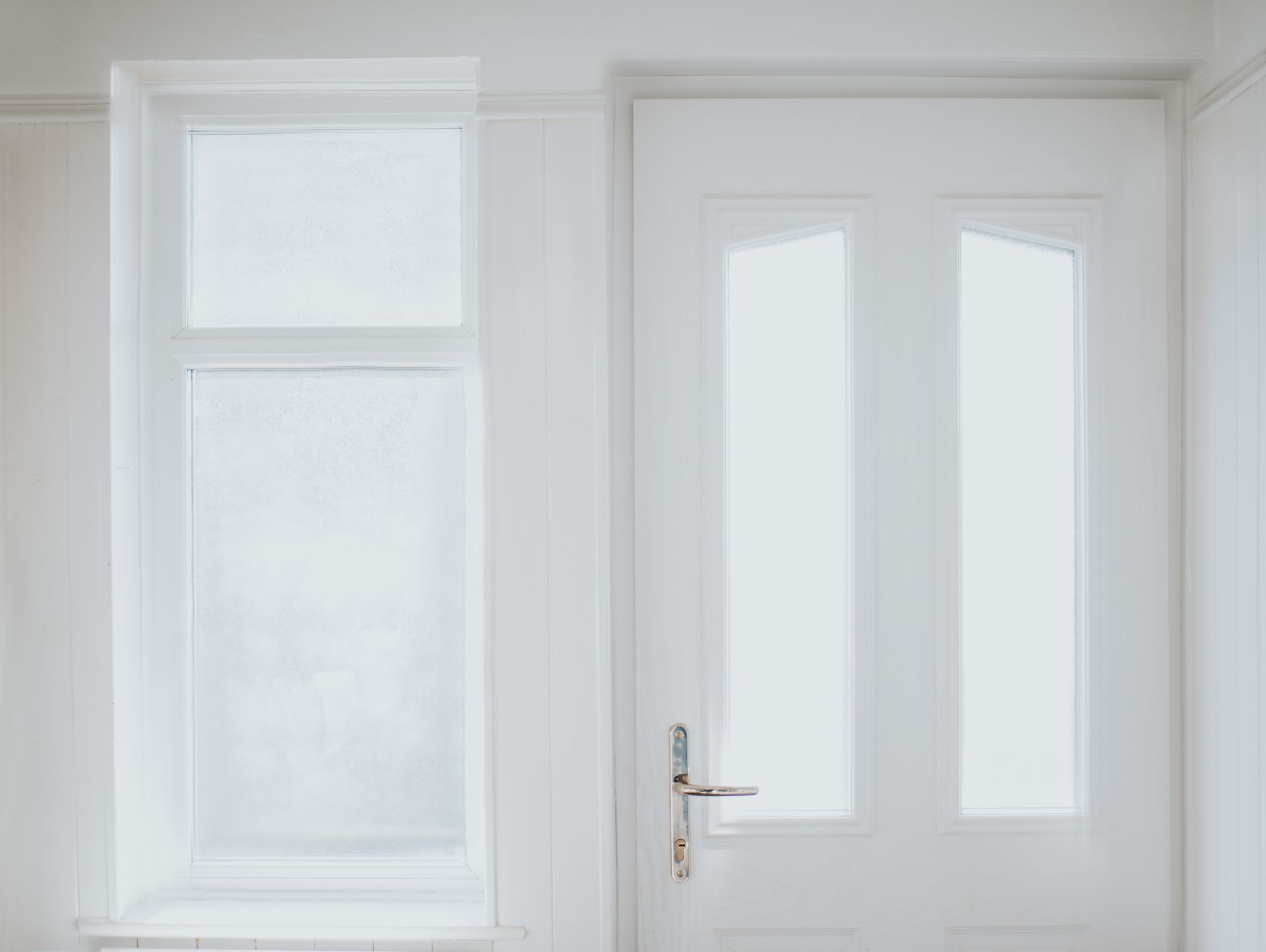 Picture of a white window and door at a residential property.