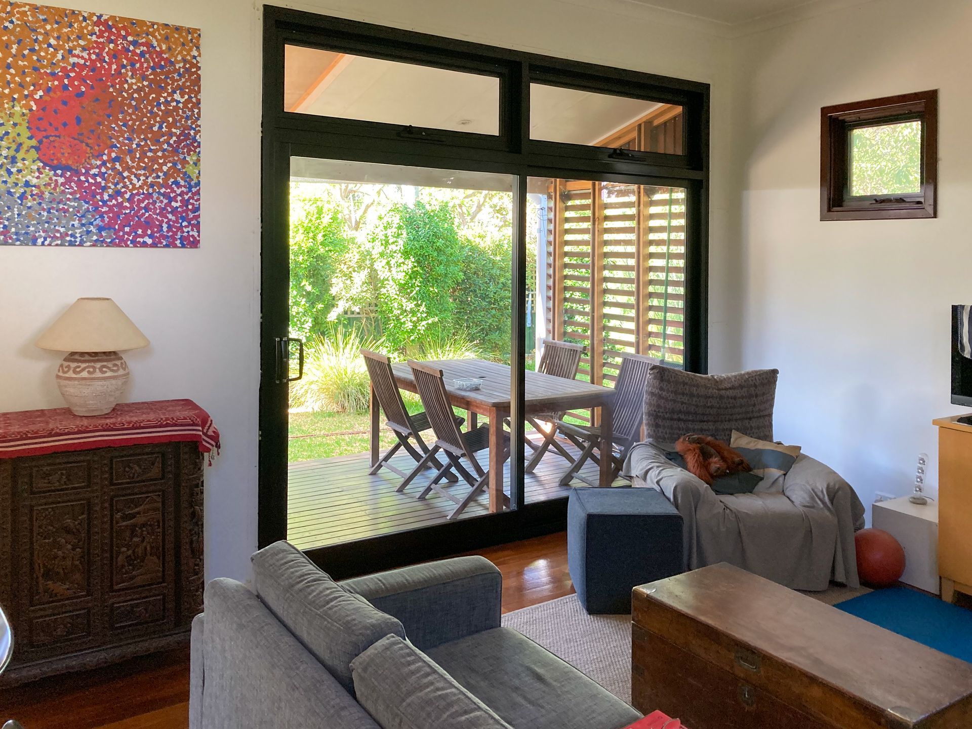 A black sliding door with two glass highlight panels and a handle A black sliding door with two glass highlight panels and a handle