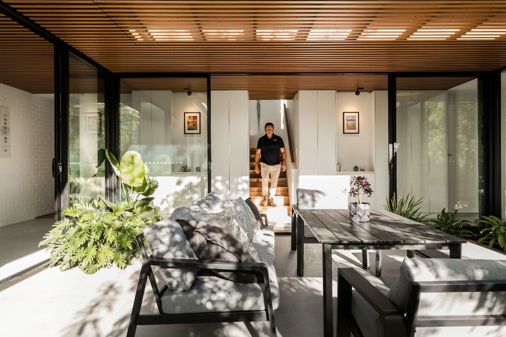 Happy customer enjoying his newly installed double-glazed windows. Happy customer enjoying his newly installed double-glazed windows.