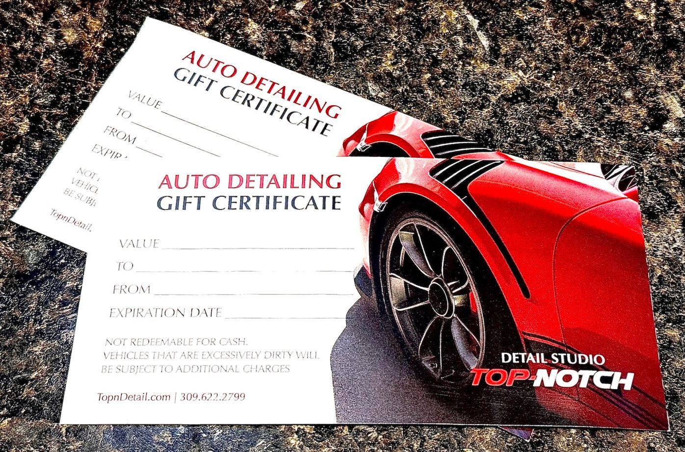 Two auto detailing gift certificates, one showing a red sports car.