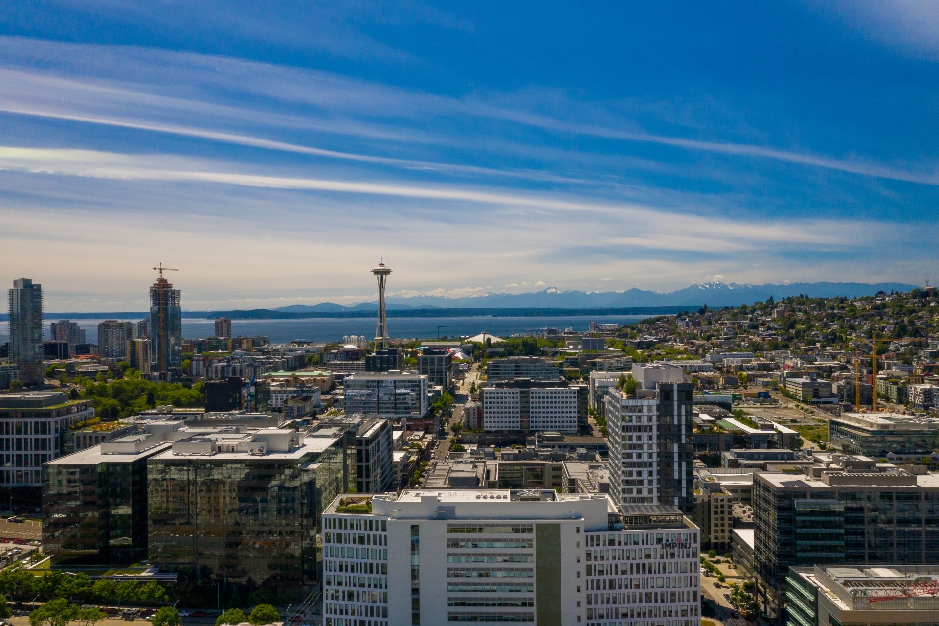 An aerial view of a city with the space needle in the background.