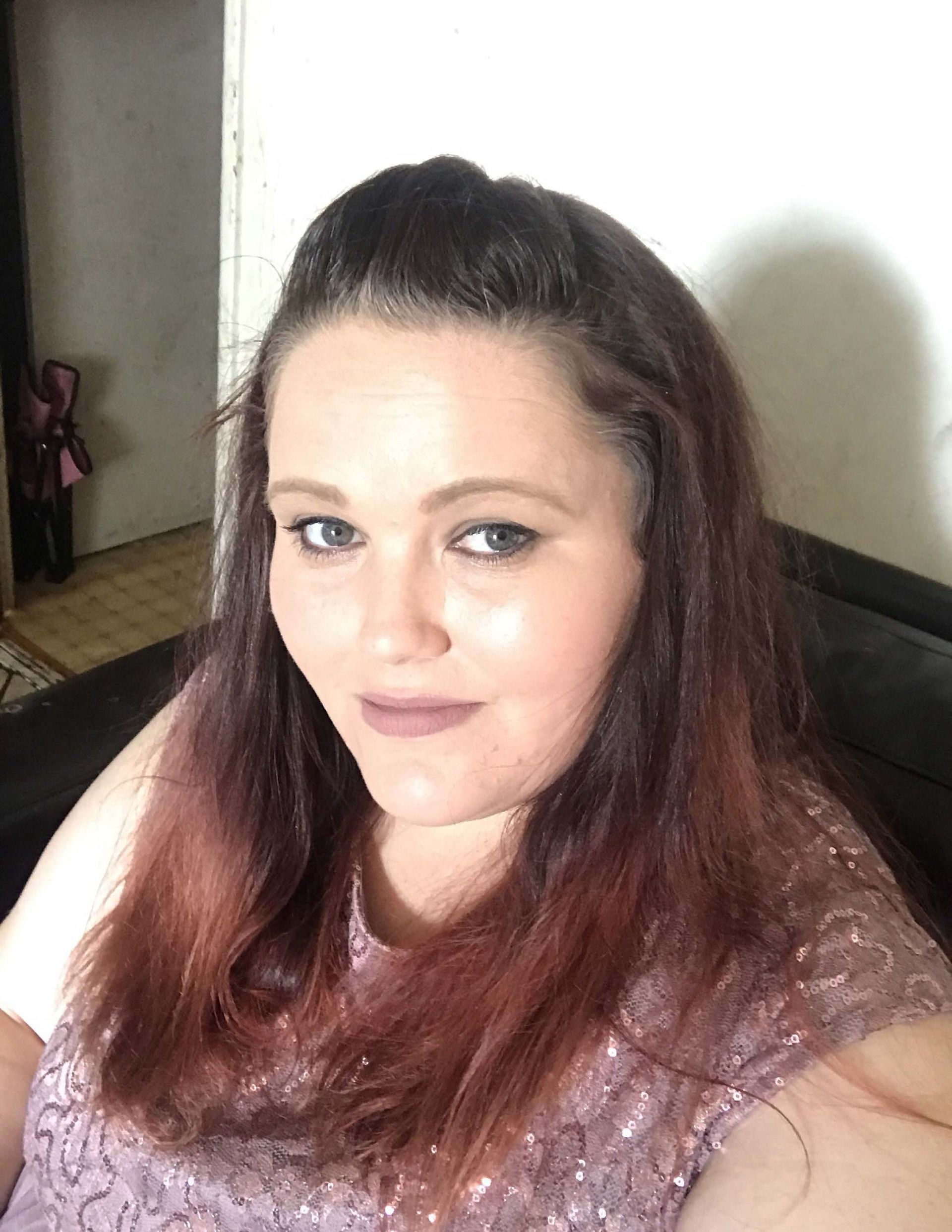 A man in a suit and tie is smiling in front of a window