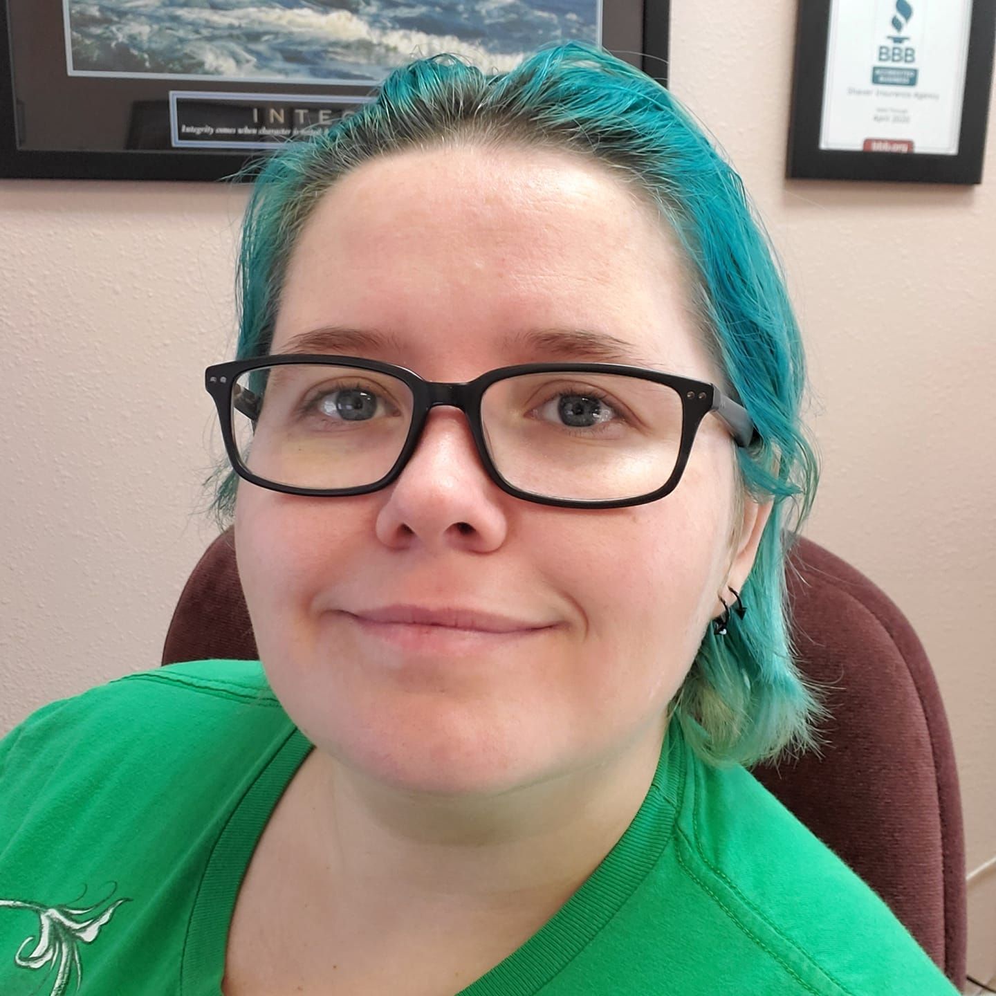 A man in a suit and tie is smiling in front of a window