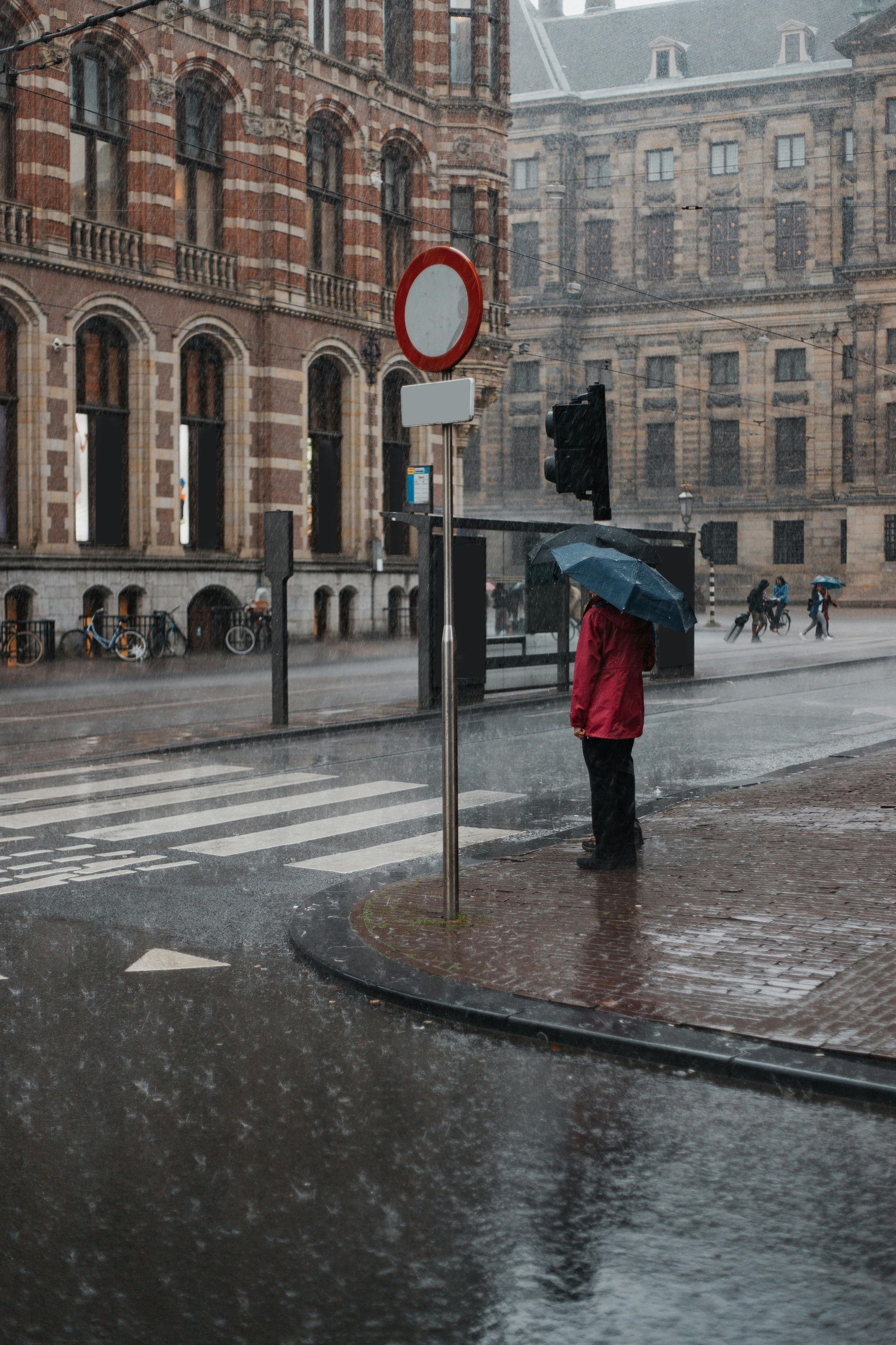A woman is carrying a little girl on her shoulders in a field at sunset.