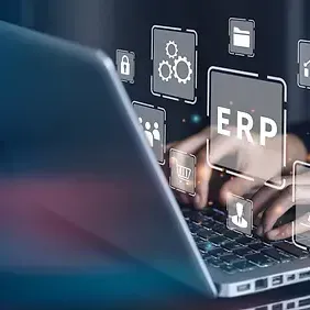 A person is typing on a laptop computer with a screen that says erp.