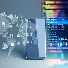 A smart phone is sitting on a table next to a computer screen.