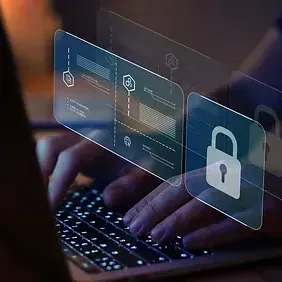 A person is typing on a laptop computer with a padlock on the screen.