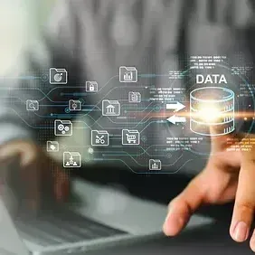 A person is using a laptop computer and pressing a button on a screen.