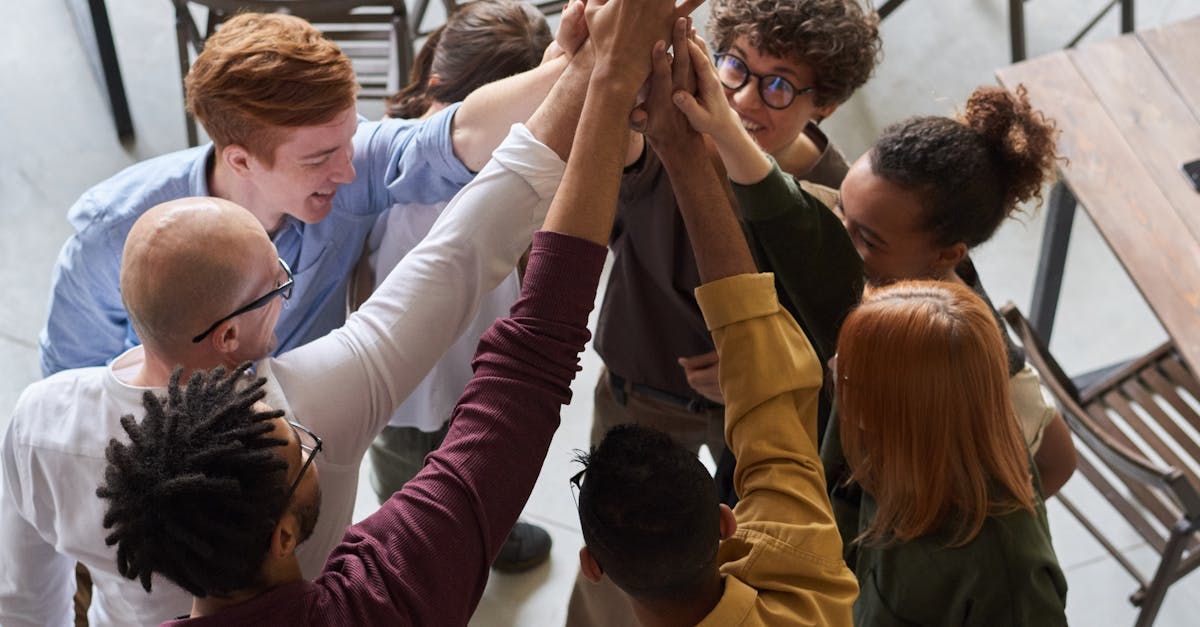 A group of people are giving each other a high five.