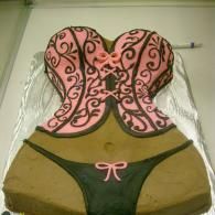 Pink corset-style top and dark green underwear with pink bow, displayed on a mannequin.