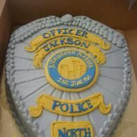 Police badge patch reading “Officer Jackson,” “Police,” and “North” in blue and gold.