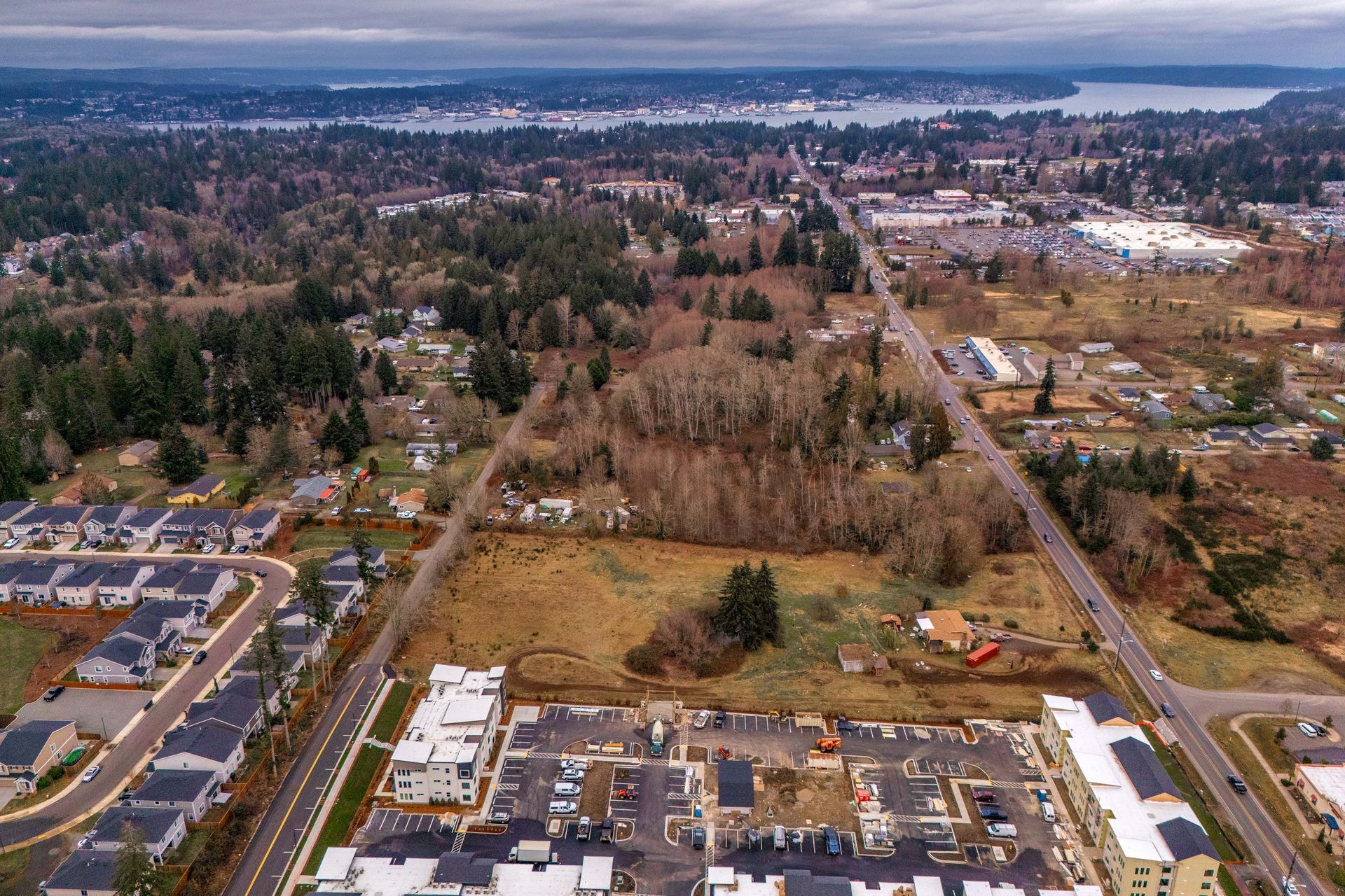 An aerial view of a residential area with a lake in the background.