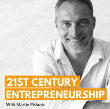 A man with the words 21st century entrepreneurship behind him