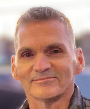 A close up of a man 's face with a blurred background.