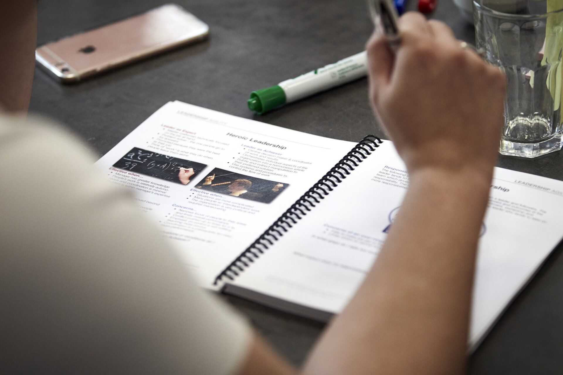 A person fills out a page on a workbook.