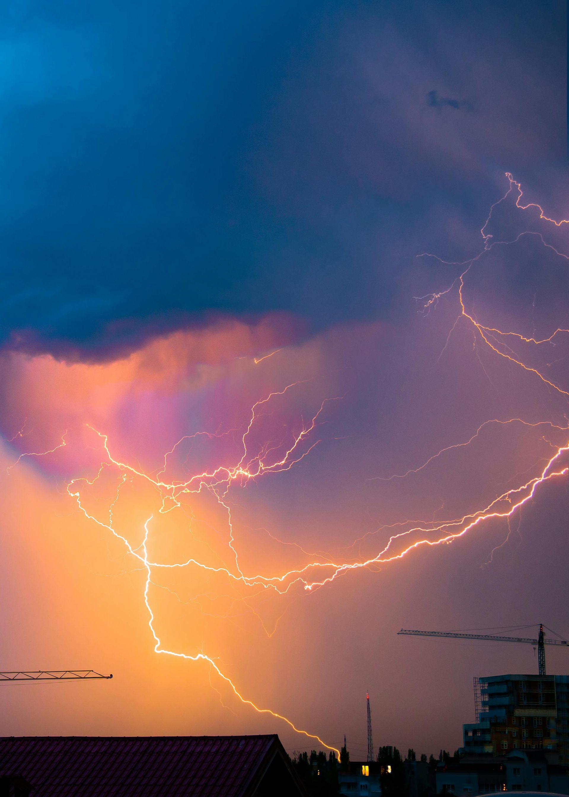 Lightning storm over a city skyline at dusk, representing crisis and disruption in leadership.