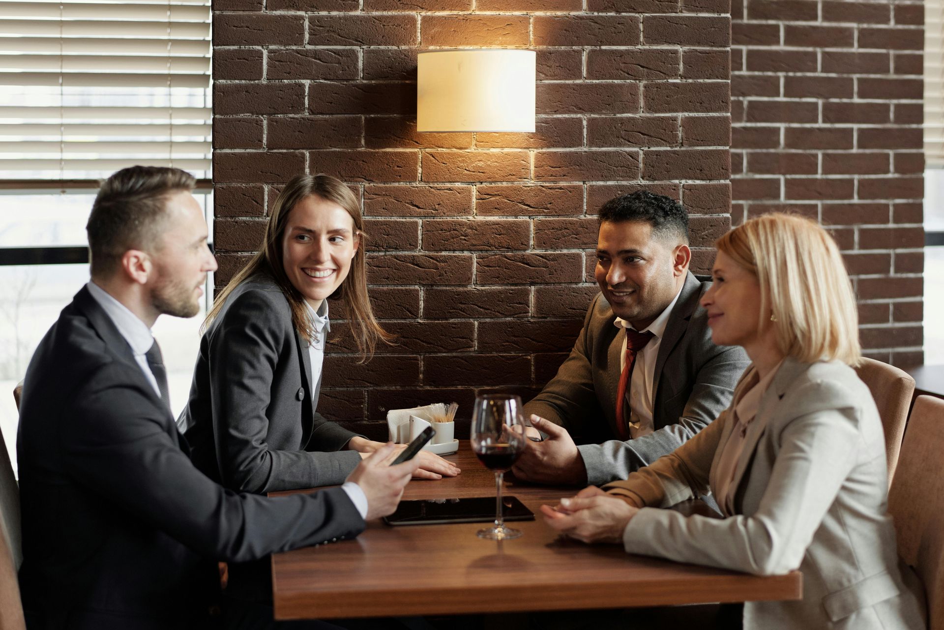A group of business people are sitting at a table in a restaurant.