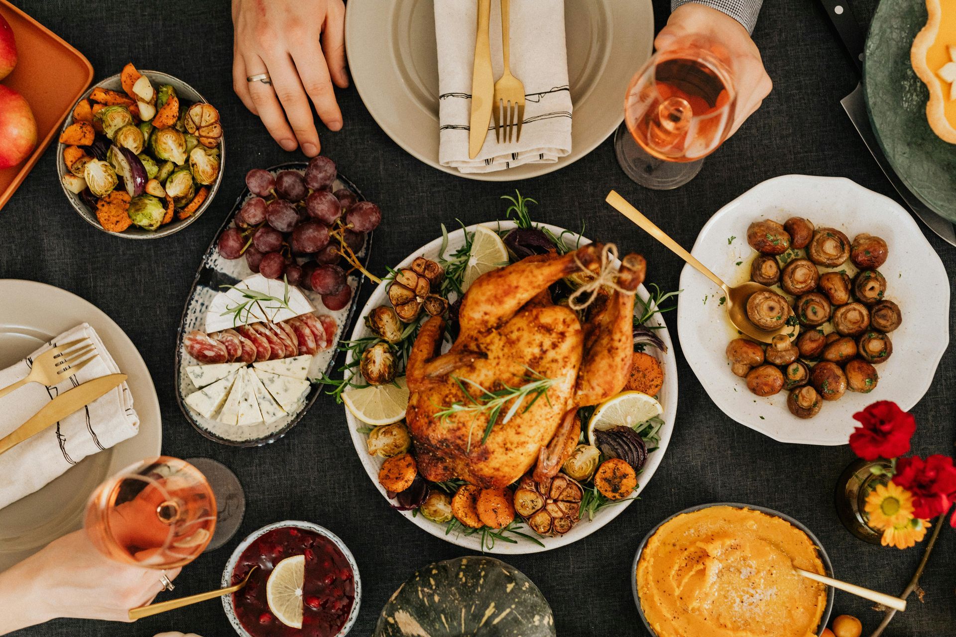 A table topped with plates of food and glasses of wine.