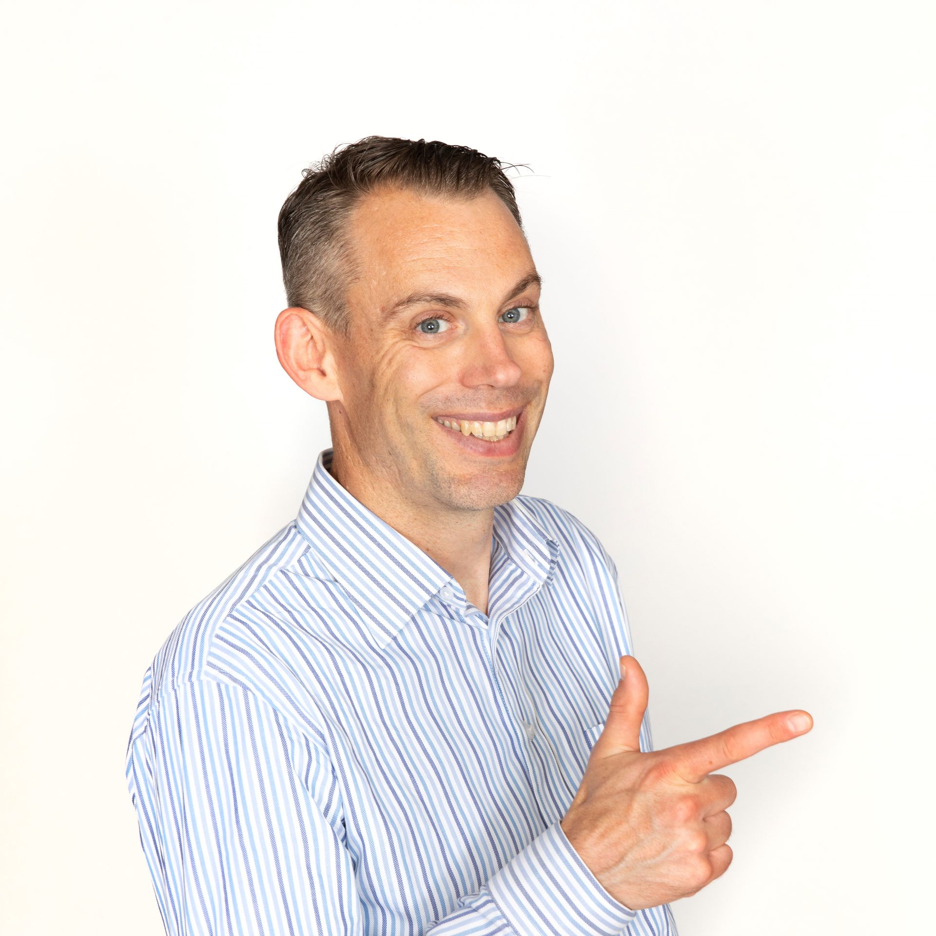 A man in a striped shirt is pointing at something with his finger.