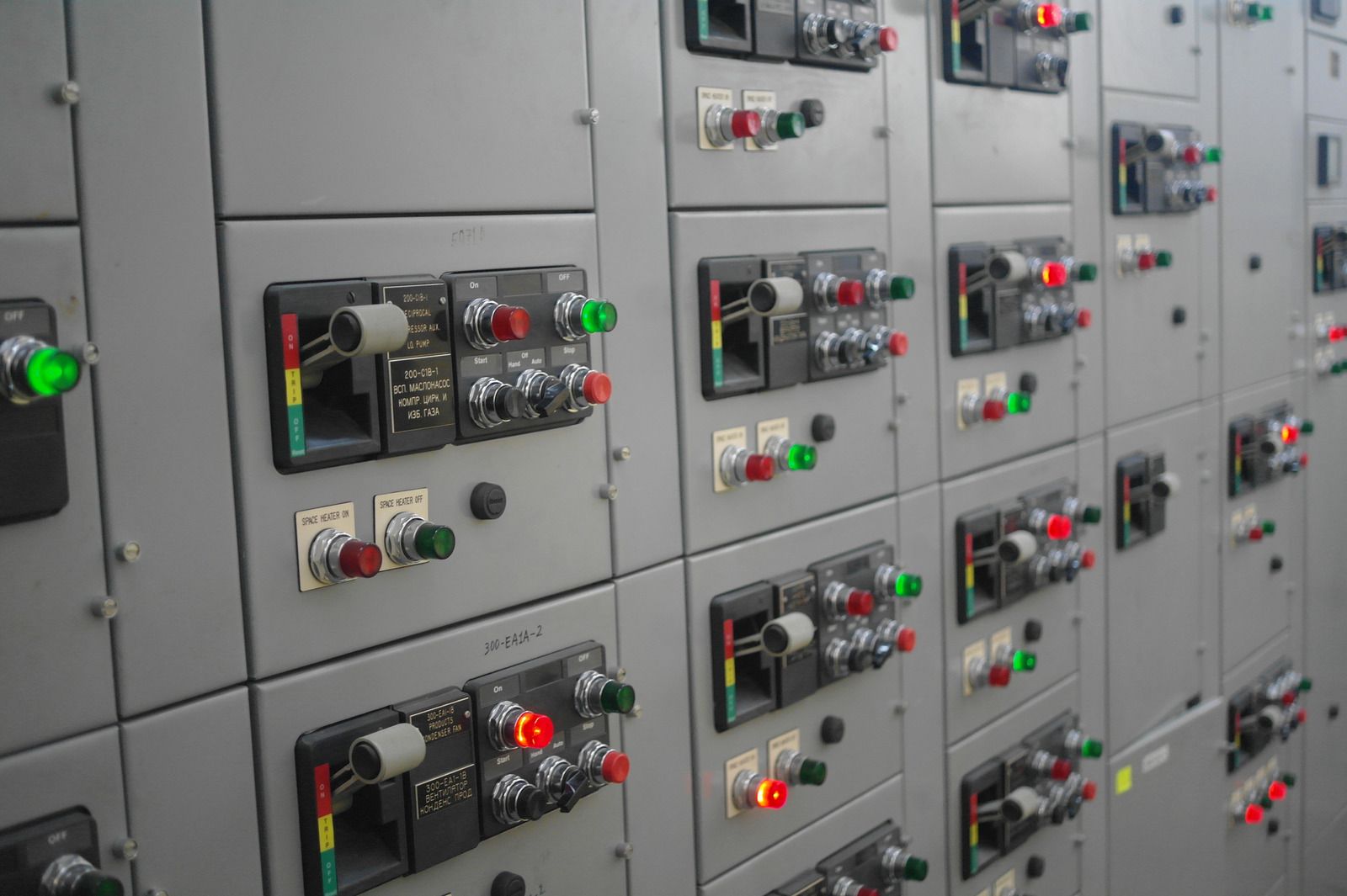 There are a lot of electrical switches and buttons on the wall.