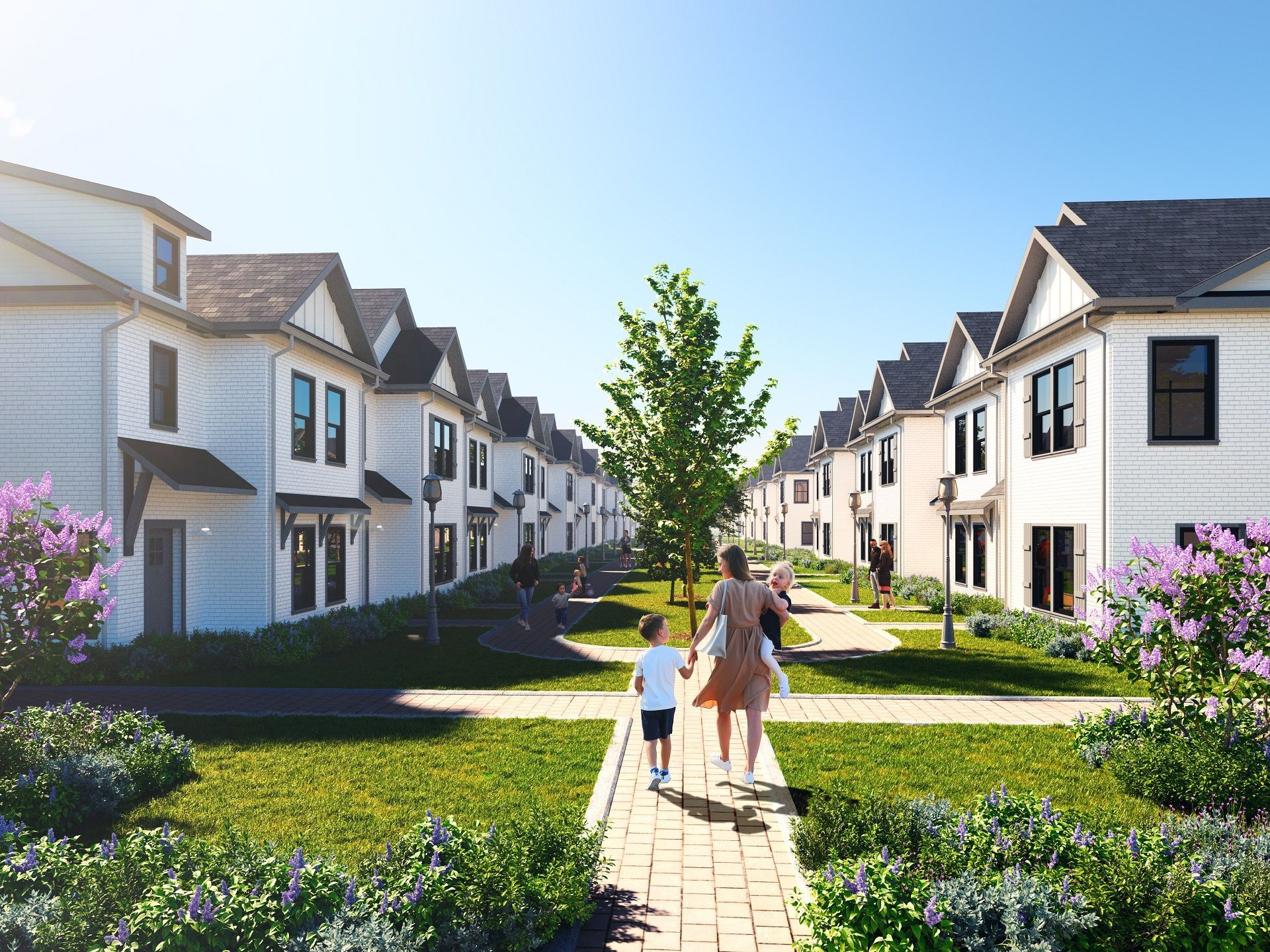 Rows of white houses with a central walkway. A woman and child walk towards the viewer. Green lawns and purple flowers line the path.
