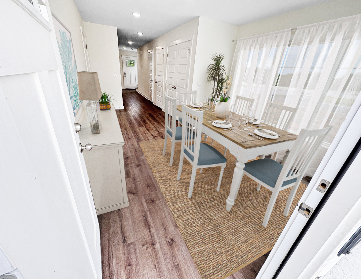 Narrow hallway with a dining room to the right and a console table to the left.