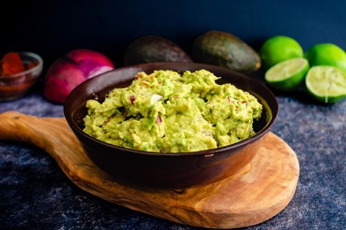 A Bowl Of Guacamole Is Sitting On A Wooden Cutting Board — Ponte Vedra Beach, FL — Science Based Wellness & Chiropractic