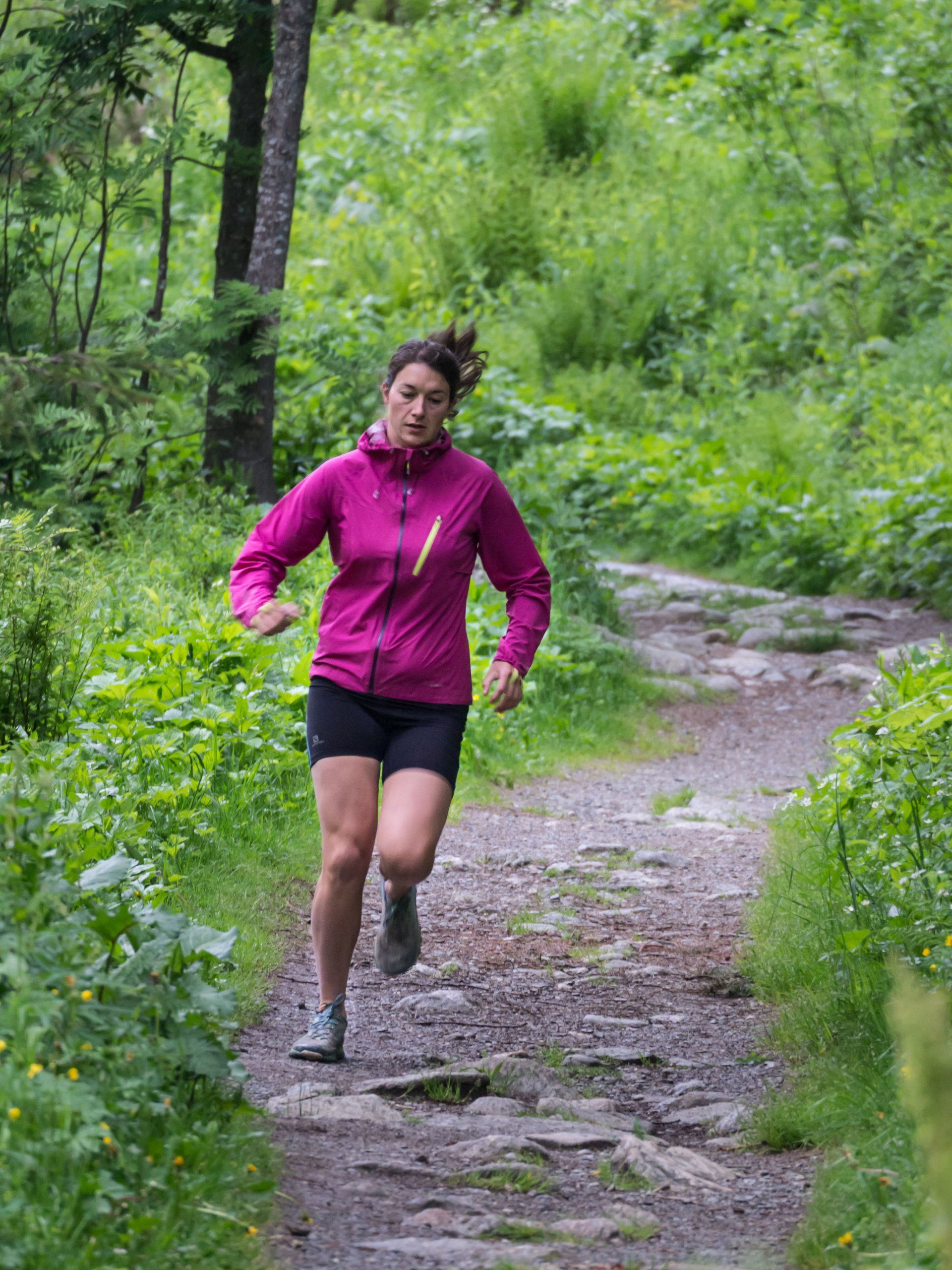 Female runner going through the forest