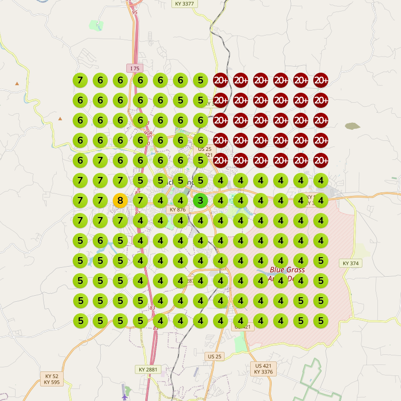 A map grid showing numerical data, mostly green, some red, and numbers between 3 and 20+, overlaid on a town's layout.