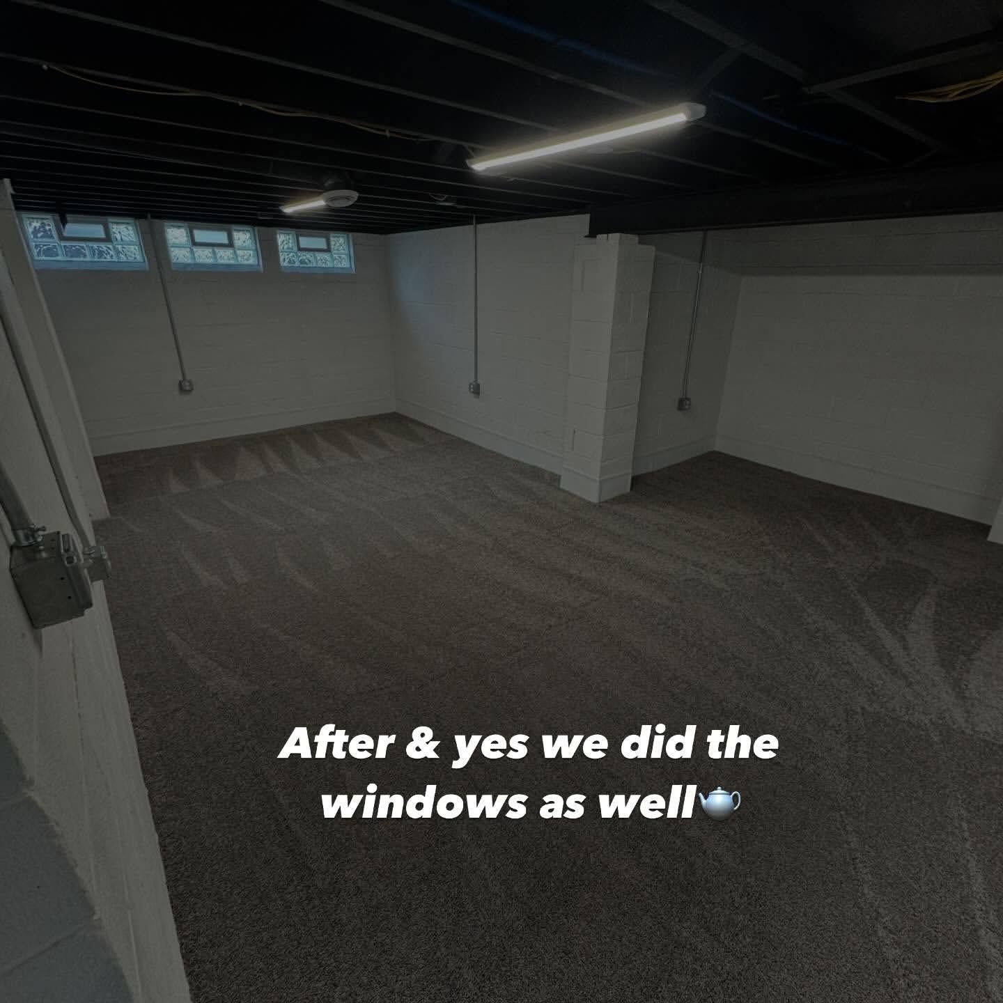 Finished basement with dark carpet, white walls, and black ceiling.