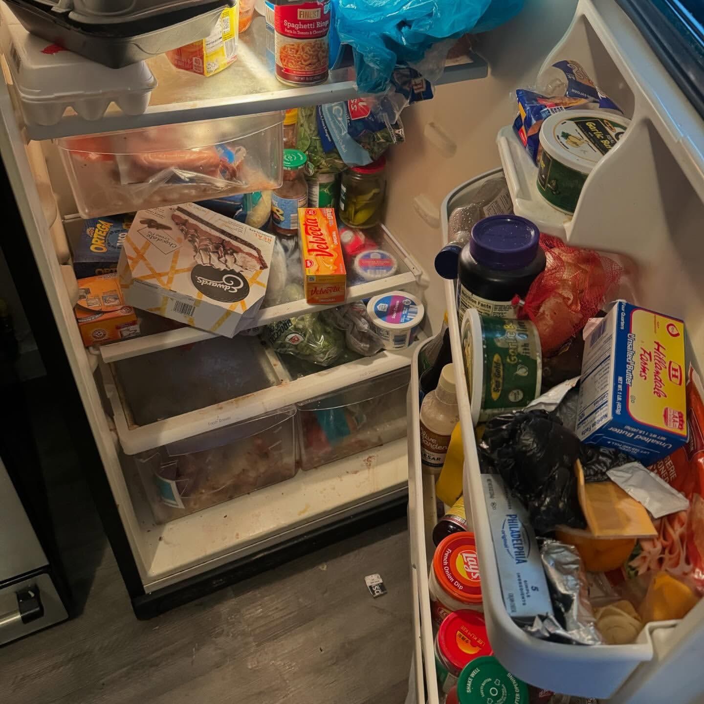 An open refrigerator, filled with food items.