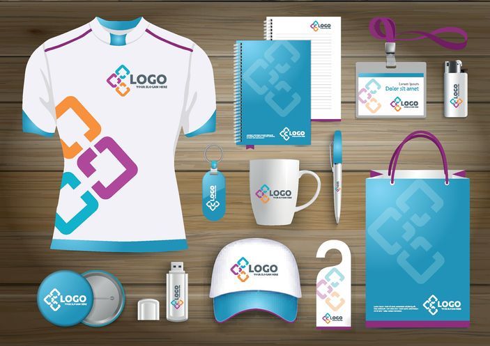 Branded shirt, mug, cap, notebook, pen, and bag on display