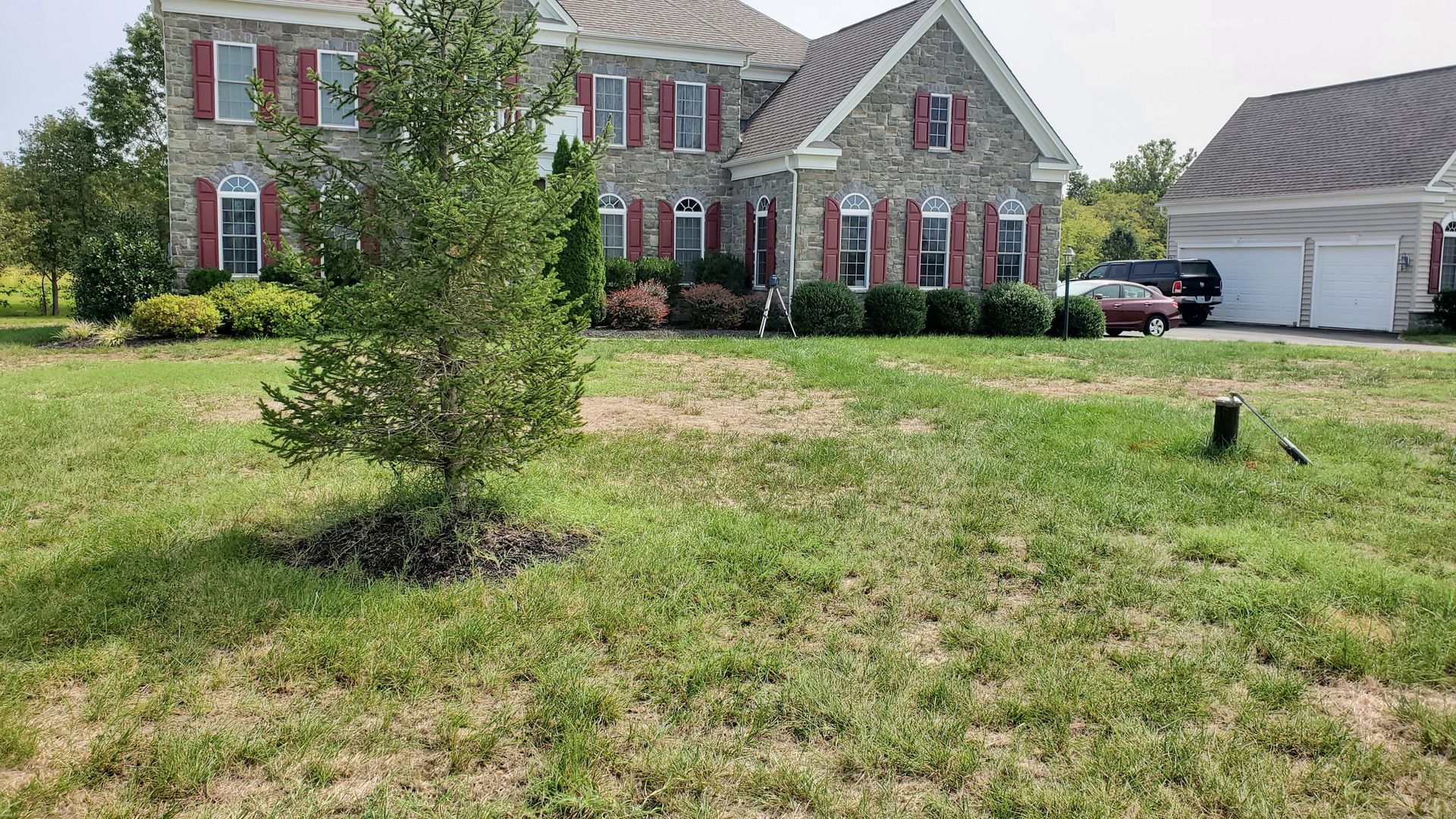 A large house with a lot of grass in front of it.