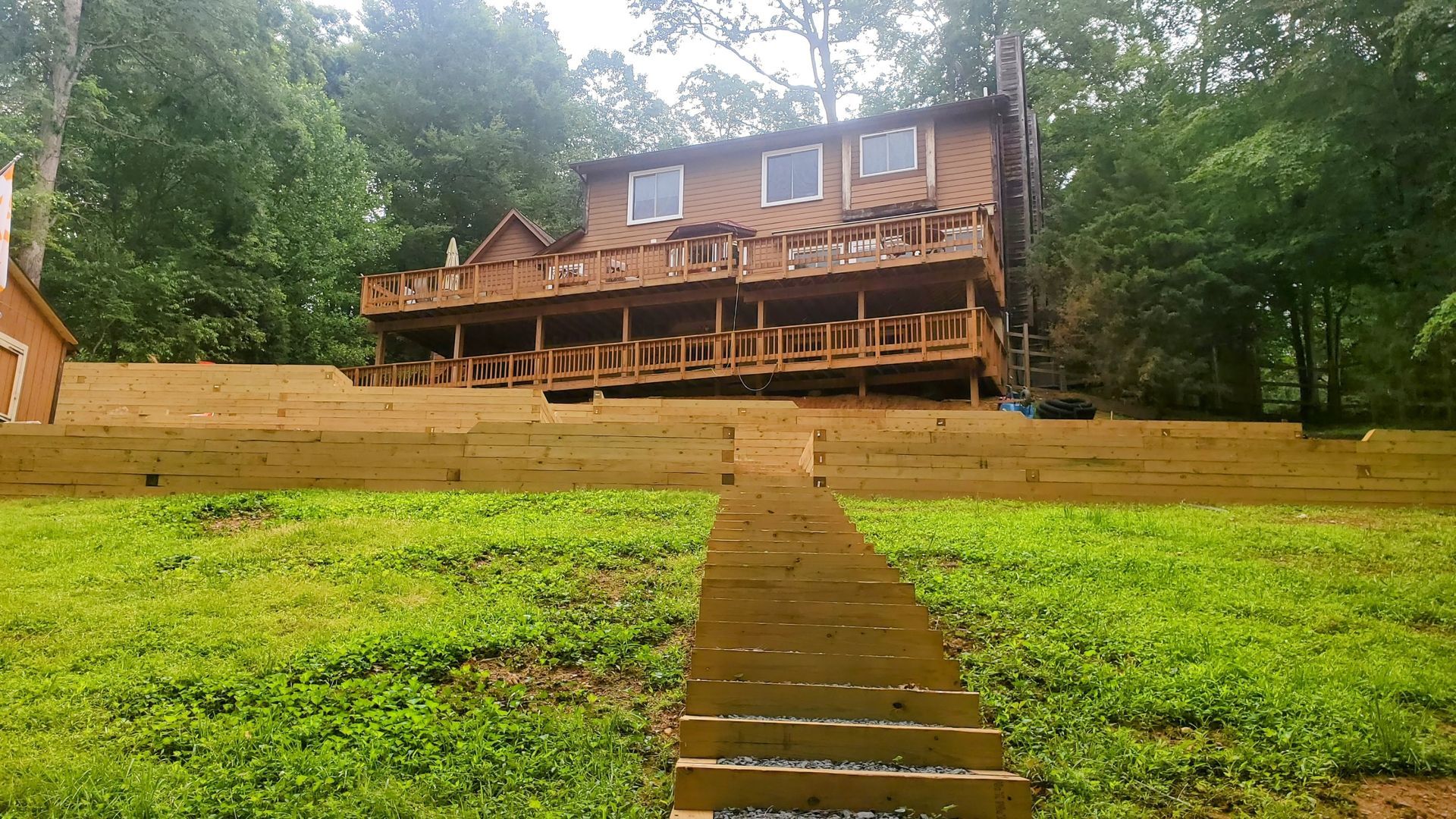A wooden house with stairs leading up to it