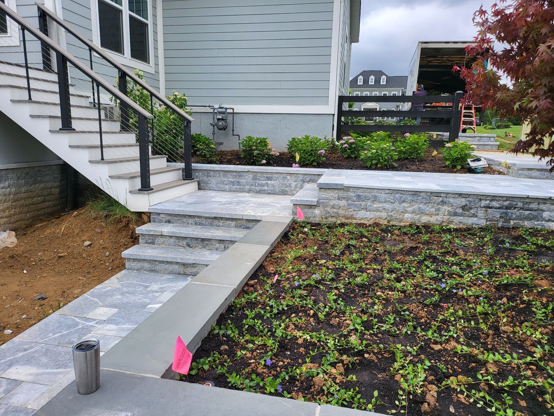 A house with stairs and a walkway in front of it.