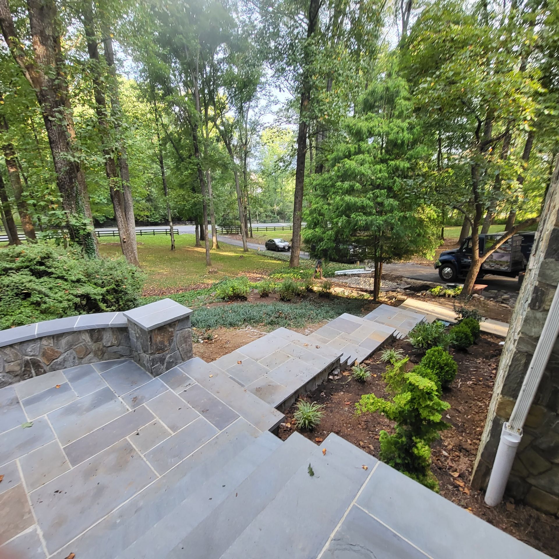 A set of stairs leading up to a house with trees in the background