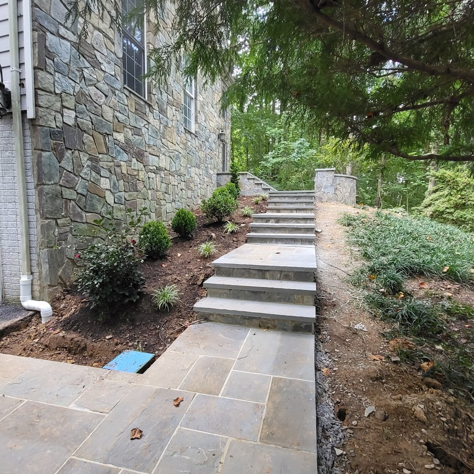 A stone walkway with stairs leading up to a house