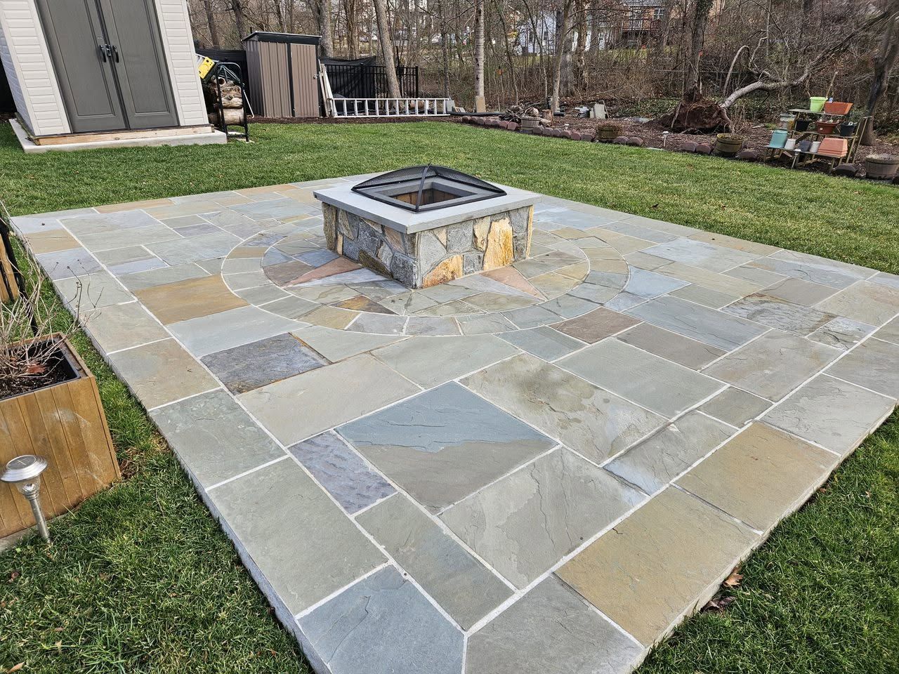 There is a fire pit in the middle of the patio.