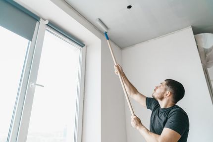 man painting the ceiling